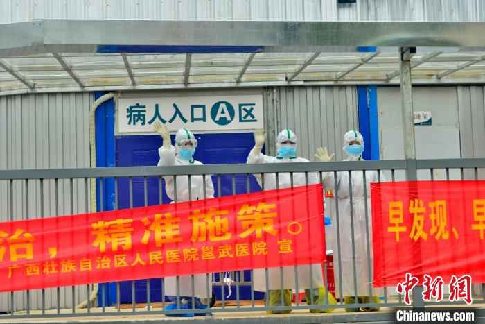 图为广西版“小汤山”医务人员与治愈患者挥手告别。 李安祺 摄  广西版“小汤山”医院在院治疗近半数确诊患者治愈出院