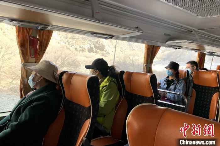 游客在景区大巴车内单排单人就坐。 李佩珊 摄  贺兰山间春风起 游客理性踏青游